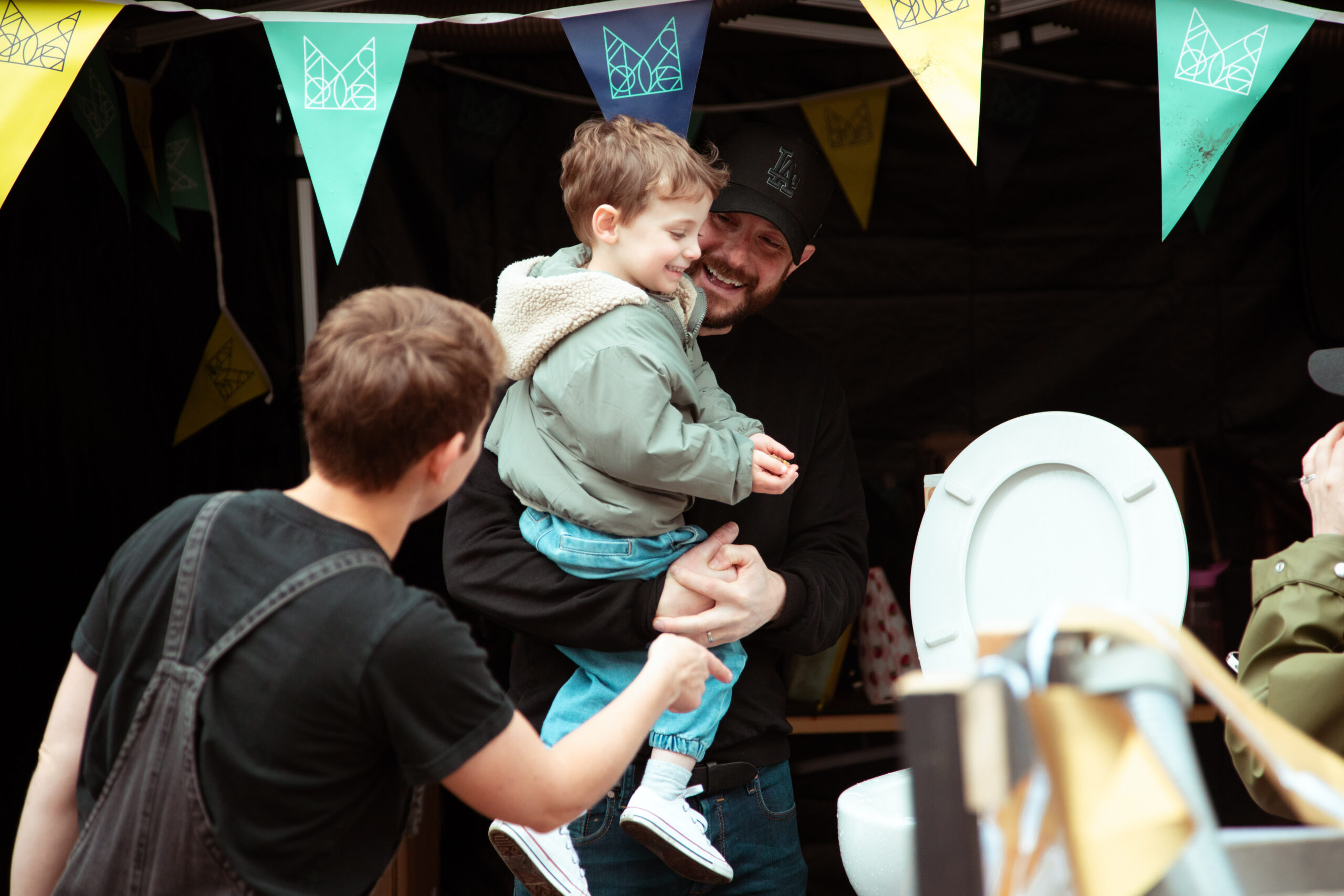 delighted boy about to flush fake poo with Dad (LR pick too)