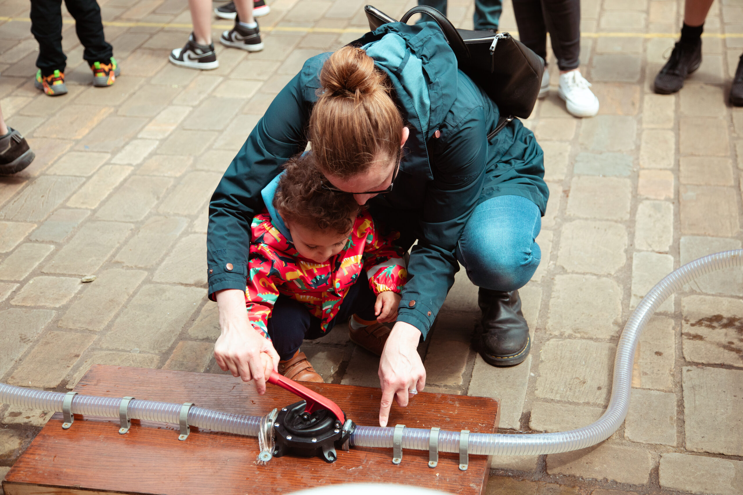 small child pumping with mum